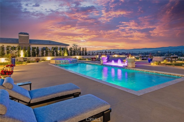 277 Crestview Ave, Camarillo, CA 93010 - pool at dusk featuring a patio, a pool with connected hot tub, and an outdoor fire pit