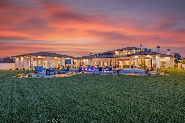 277 Crestview Ave, Camarillo, CA 93010 - back of property at dusk with a patio area, a swimming pool, a chimney, a yard, and outdoor lounge area