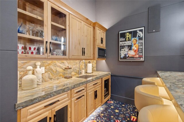 277 Crestview Ave, Camarillo, CA 93010 - bar area featuring a sink, stainless steel microwave, decorative backsplash, and a wainscoted wall