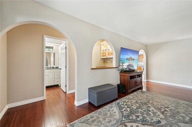 1824 S Starfire Ave, Corona, CA 92879 - hallway featuring dark wood-style flooring, arched walkways, and baseboards