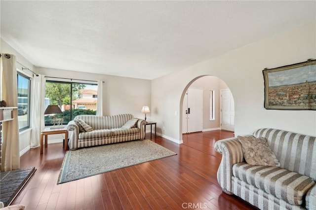 1824 S Starfire Ave, Corona, CA 92879 - living room featuring arched walkways, wood finished floors, and baseboards