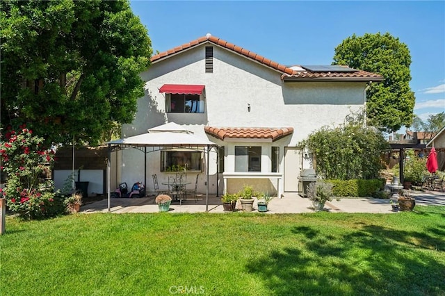 1824 S Starfire Ave, Corona, CA 92879 - rear view of house with a patio area, a tiled roof, solar panels, and stucco siding