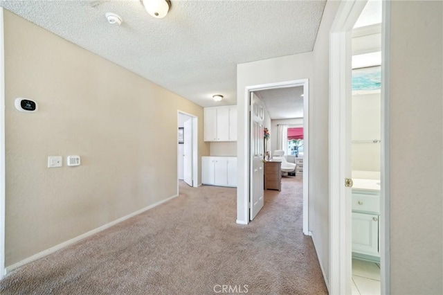 1824 S Starfire Ave, Corona, CA 92879 - hall with light colored carpet, a textured ceiling, and baseboards