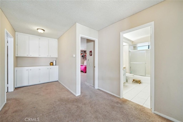 1824 S Starfire Ave, Corona, CA 92879 - corridor with light colored carpet, baseboards, a textured ceiling, and light tile patterned floors