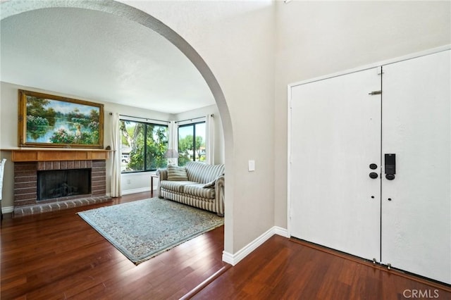 1824 S Starfire Ave, Corona, CA 92879 - foyer featuring arched walkways, wood finished floors, baseboards, and a fireplace