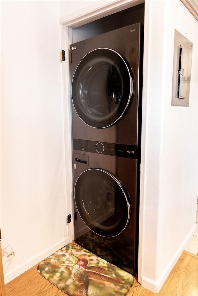 564 Margie Pl, Nipomo, CA 93444 - laundry room with estacked washer and dryer, wood finished floors, and baseboards
