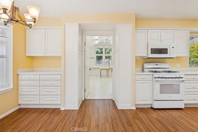 855 Dahlia Ln, San Luis Obispo, CA 93401 - kitchen featuring white appliances, light wood-style floors, white cabinetry, a chandelier, and light countertops
