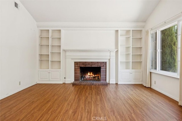 855 Dahlia Ln, San Luis Obispo, CA 93401 - unfurnished living room with wood finished floors, a fireplace, baseboards, vaulted ceiling, and built in features