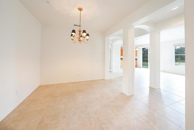 23425 Mountain Peak Rd, Ramona, CA 92065 - empty room featuring arched walkways, a chandelier, light tile patterned floors, and baseboards