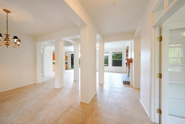 23425 Mountain Peak Rd, Ramona, CA 92065 - hallway with a chandelier, arched walkways, light tile patterned floors, and baseboards