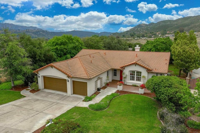 23425 Mountain Peak Rd, Ramona, CA 92065 - view of front facade featuring a tiled roof, an attached garage, stucco siding, and a mountain view