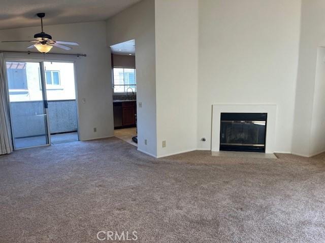 24222 Sylvan Glen Rd Unit F, Diamond Bar, CA 91765 - unfurnished living room featuring carpet, ceiling fan, a fireplace with flush hearth, and a sink