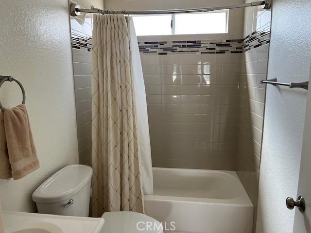 24222 Sylvan Glen Rd Unit F, Diamond Bar, CA 91765 - bathroom featuring toilet and shower / bathtub combination with curtain