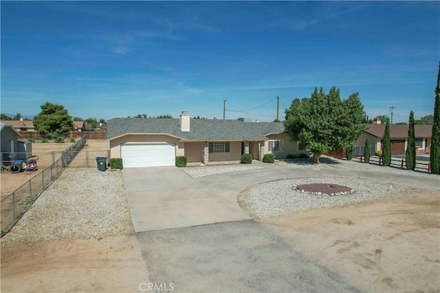 11540 Mohawk Rd, Apple Valley, CA 92308 - ranch-style house with stucco siding, concrete driveway, fence, a chimney, and an attached garage