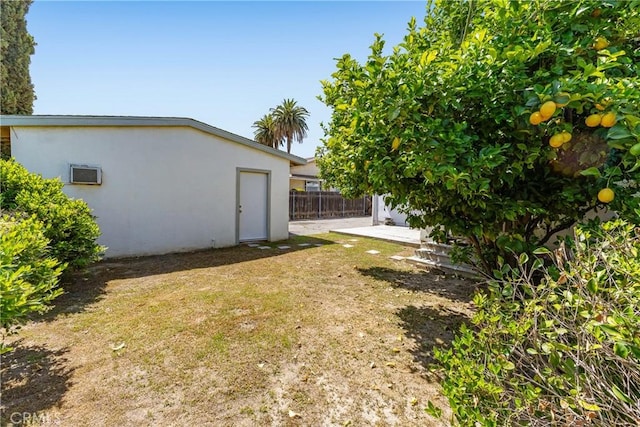 view of yard with a wall mounted air conditioner and a patio area