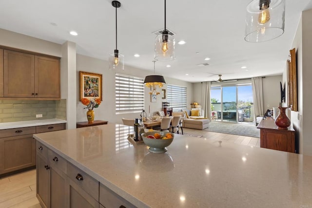 6132 Colt Pl Unit 101, Carlsbad, CA 92009 - kitchen featuring tasteful backsplash, decorative light fixtures, light wood finished floors, open floor plan, and recessed lighting
