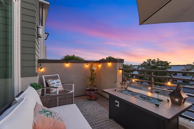 6132 Colt Pl Unit 101, Carlsbad, CA 92009 - patio terrace at dusk with an outdoor living space with a fire pit
