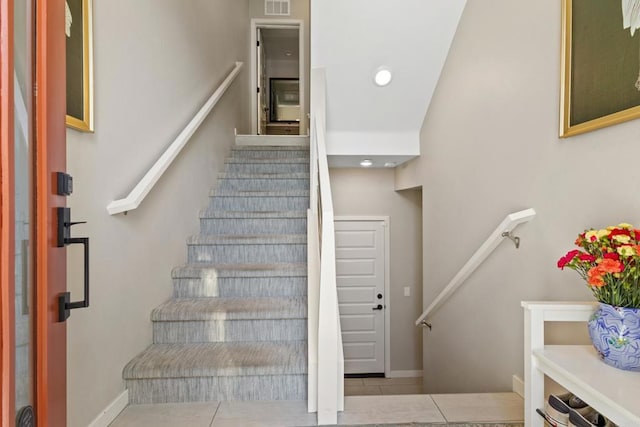 6132 Colt Pl Unit 101, Carlsbad, CA 92009 - stairs featuring tile patterned floors and baseboards