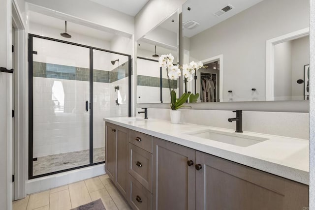 6132 Colt Pl Unit 101, Carlsbad, CA 92009 - bathroom with a shower stall, double vanity, a chandelier, and a walk in closet