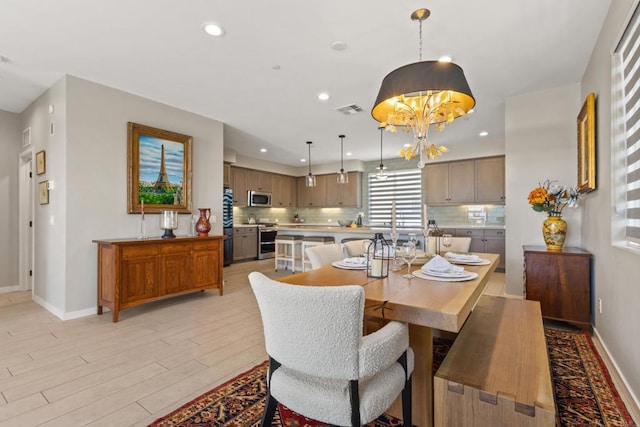 6132 Colt Pl Unit 101, Carlsbad, CA 92009 - dining area with light wood-type flooring, recessed lighting, and a chandelier