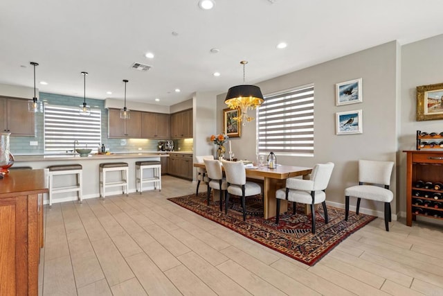 6132 Colt Pl Unit 101, Carlsbad, CA 92009 - dining room with light wood-style floors, recessed lighting, and a chandelier