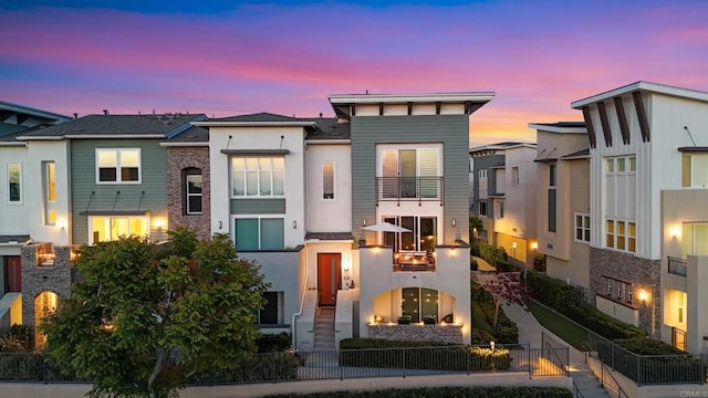 6132 Colt Pl Unit 101, Carlsbad, CA 92009 - view of front facade featuring stucco siding, a fenced front yard, and a balcony