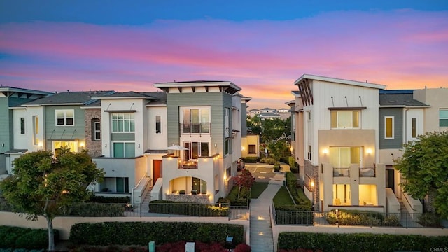 6132 Colt Pl Unit 101, Carlsbad, CA 92009 - view of front of property with a balcony, a fenced front yard, stucco siding, and a residential view
