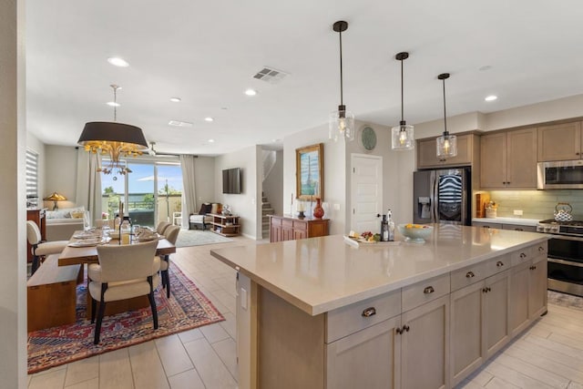 6132 Colt Pl Unit 101, Carlsbad, CA 92009 - kitchen featuring appliances with stainless steel finishes, open floor plan, backsplash, a center island, and recessed lighting