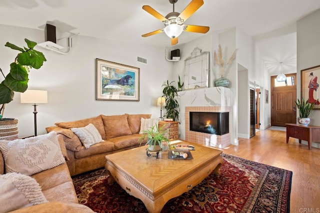 1850 Willowhaven Rd, Encinitas, CA 92024 - living room featuring light wood-style flooring, a tiled fireplace, a ceiling fan, and lofted ceiling