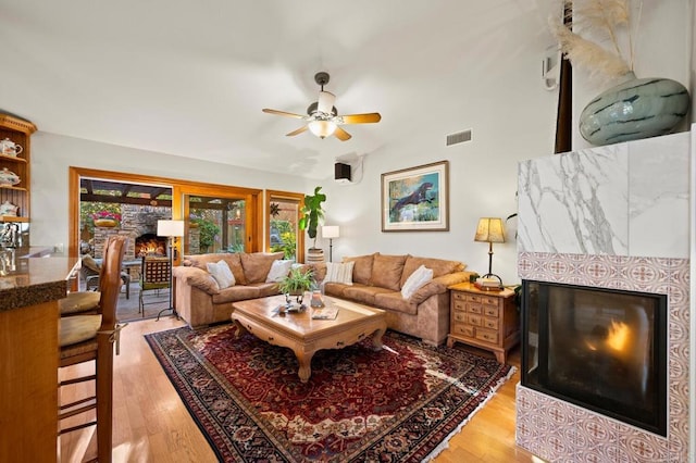 1850 Willowhaven Rd, Encinitas, CA 92024 - living room featuring a glass covered fireplace, light wood-style floors, a ceiling fan, and vaulted ceiling