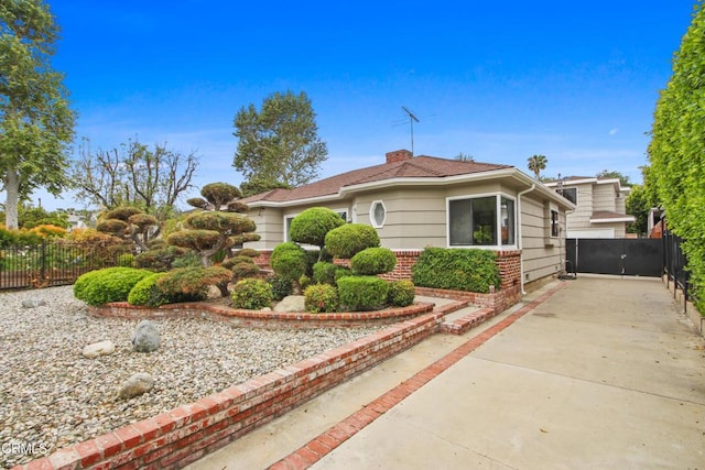 5131 Greenbush Ave, Sherman Oaks, CA 91423 - view of front facade with a chimney and driveway