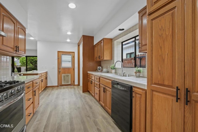 5131 Greenbush Ave, Sherman Oaks, CA 91423 - kitchen featuring dishwasher, stainless steel range with gas cooktop, backsplash, tile countertops, and light wood-type flooring