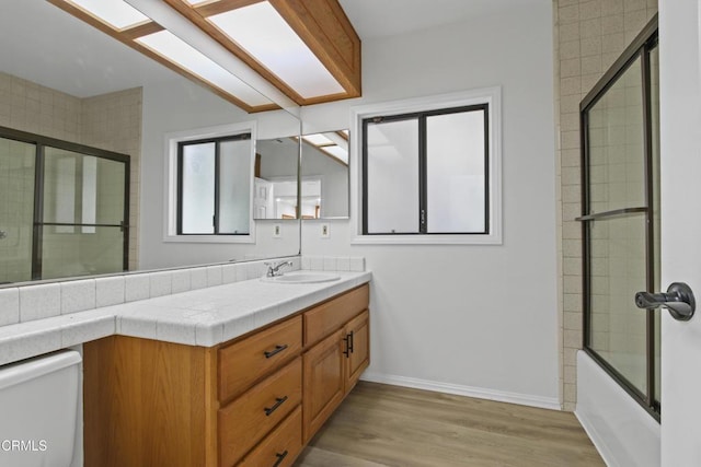 5131 Greenbush Ave, Sherman Oaks, CA 91423 - full bathroom with vanity, wood finished floors, and combined bath / shower with glass door