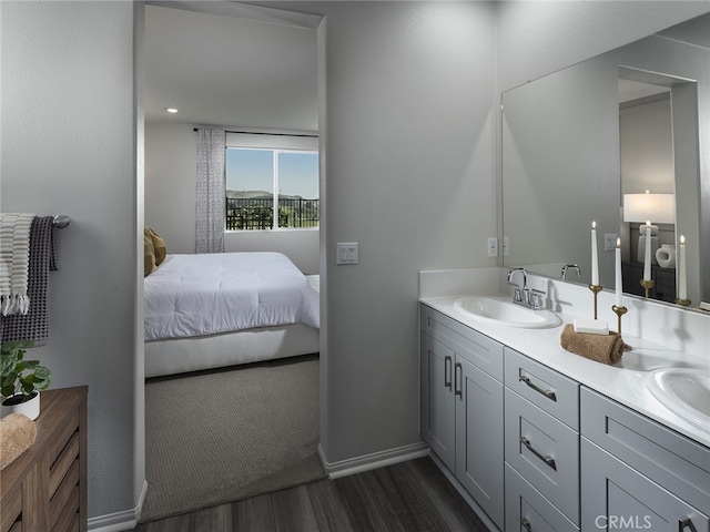 35203 Lopez Ln, Beaumont, CA 92223 - ensuite bathroom featuring wood finished floors, double vanity, and baseboards