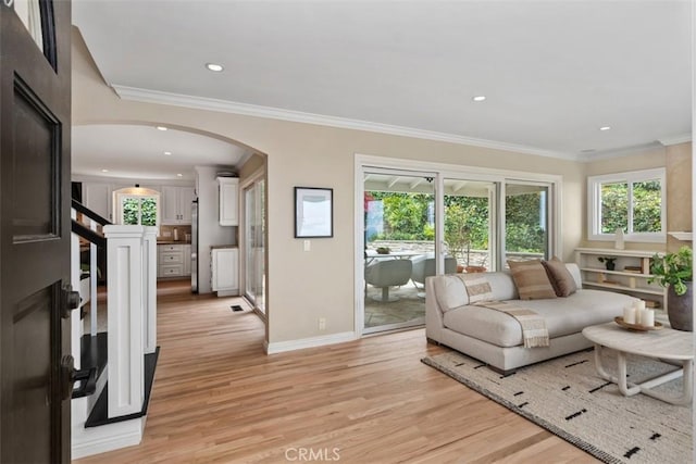1981 San Remo, Laguna Beach, CA 92651 - living room featuring arched walkways, plenty of natural light, light wood finished floors, recessed lighting, and ornamental molding