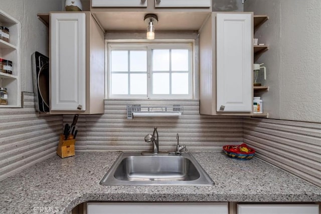 61961 Aster Pl, Joshua Tree, CA 92252 - kitchen featuring open shelves, a sink, white cabinets, and tasteful backsplash
