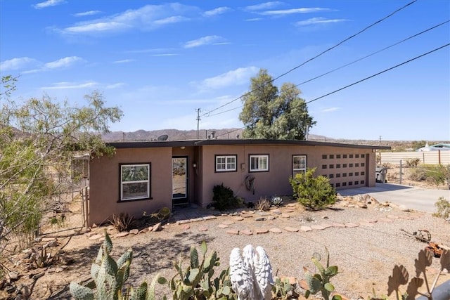61961 Aster Pl, Joshua Tree, CA 92252 - ranch-style house with concrete driveway, stucco siding, a garage, and fence
