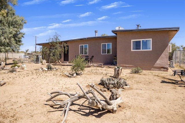 61961 Aster Pl, Joshua Tree, CA 92252 - back of property featuring stucco siding and fence