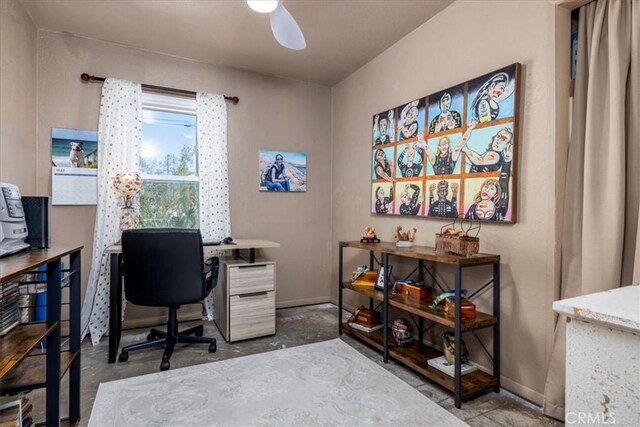 61961 Aster Pl, Joshua Tree, CA 92252 - home office featuring ceiling fan, concrete floors, and baseboards