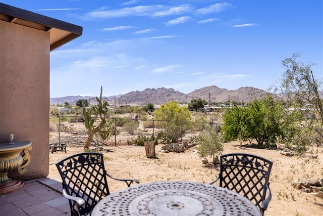 61961 Aster Pl, Joshua Tree, CA 92252 - view of patio / terrace featuring a mountain view, outdoor dining area, and fence