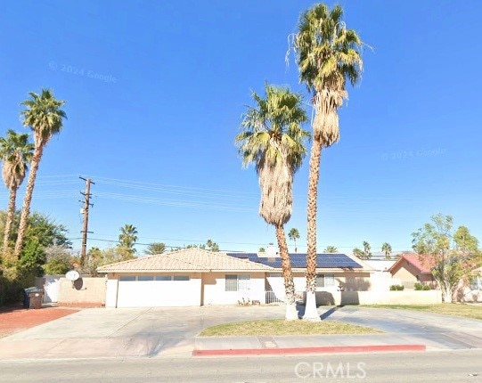 3140 E Vista Chino E, Vista Chino, Palm Springs, CA 92262 - ranch-style house with driveway, roof mounted solar panels, and an attached garage