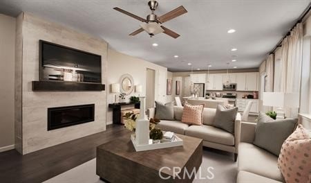 610 Clarence Muse Loop, Perris, CA 92570 - living area featuring wood finished floors, ceiling fan, a glass covered fireplace, and recessed lighting