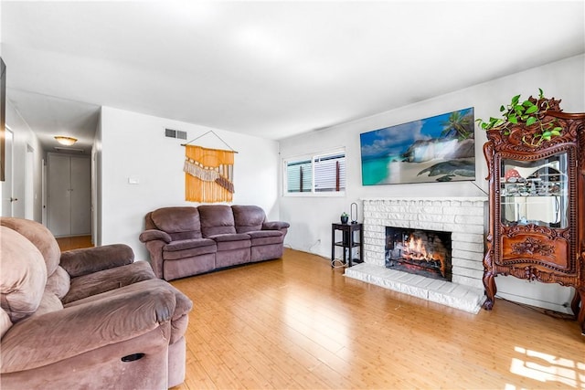 17331 Newland St, Huntington Beach, CA 92647 - living area featuring a brick fireplace and light wood-style floors