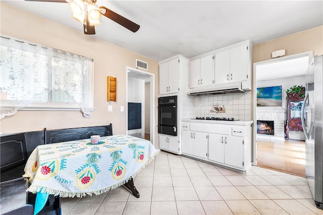 17331 Newland St, Huntington Beach, CA 92647 - kitchen featuring oven, freestanding refrigerator, ceiling fan, under cabinet range hood, and stovetop