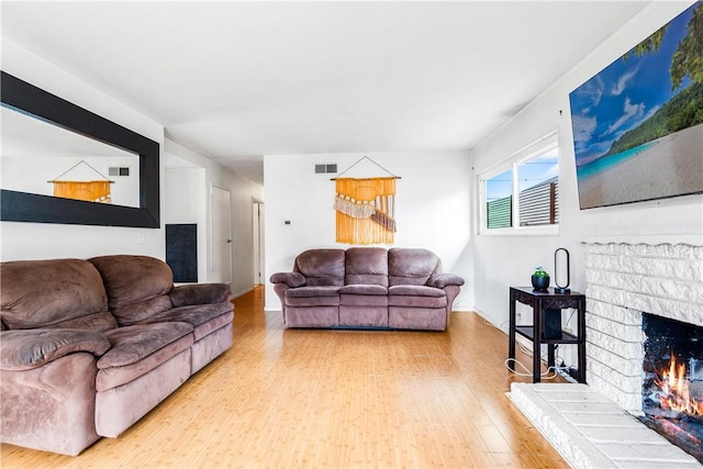 17331 Newland St, Huntington Beach, CA 92647 - living area with wood finished floors, a brick fireplace, and baseboards