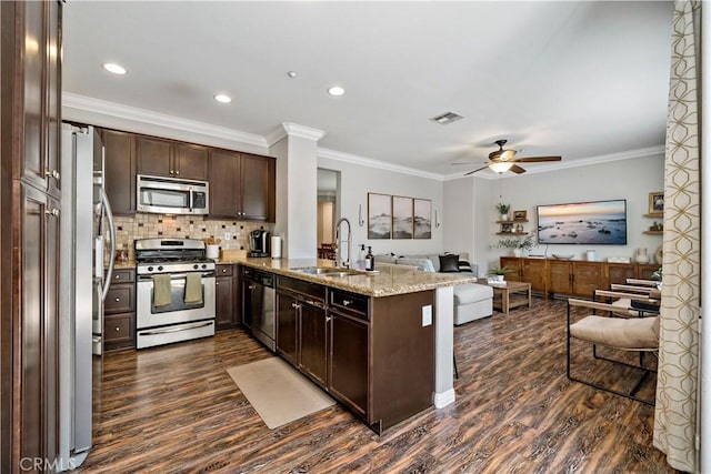 27423 Larabee Ct Unit 3, Murrieta, CA 92562 - kitchen featuring appliances with stainless steel finishes, a sink, dark wood-style floors, open floor plan, and crown molding