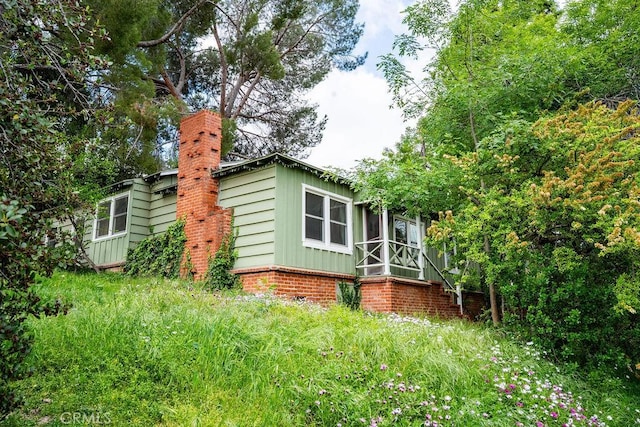 22460 Venido Rd, Woodland Hills, CA 91364 - view of side of property featuring a chimney and board and batten siding