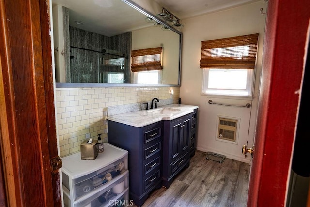 22460 Venido Rd, Woodland Hills, CA 91364 - full bathroom featuring tasteful backsplash, heating unit, wood finished floors, vanity, and a shower
