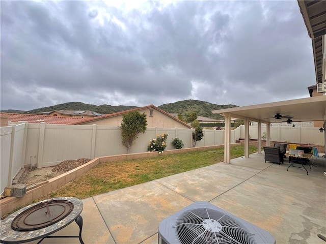18016 Ribwort Rd, San Bernardino, CA 92407 - view of patio / terrace with ceiling fan, outdoor lounge area, a mountain view, a fenced backyard, and central AC