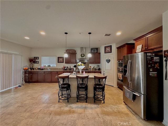 18016 Ribwort Rd, San Bernardino, CA 92407 - kitchen featuring appliances with stainless steel finishes, wall chimney exhaust hood, a kitchen breakfast bar, a center island with sink, and hanging light fixtures